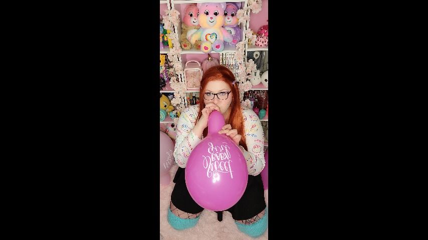 Nerdy Ginger blows pink balloons - March 16, 2022